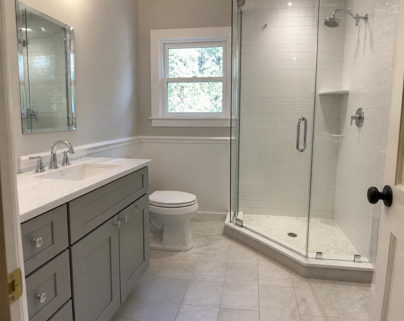 Same bathroom after remodel with tiled glass shower and new vanity