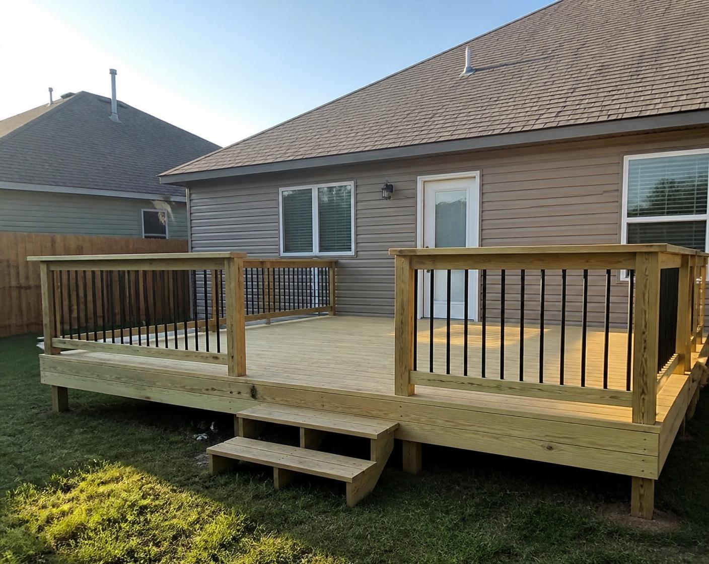 Newly built backyard wood deck with railing and steps