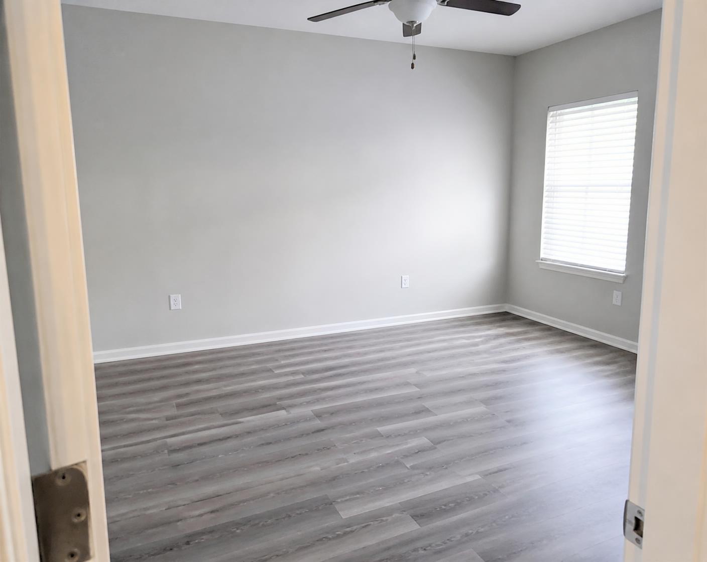 Same room turned over with fresh paint, new flooring and clean trim